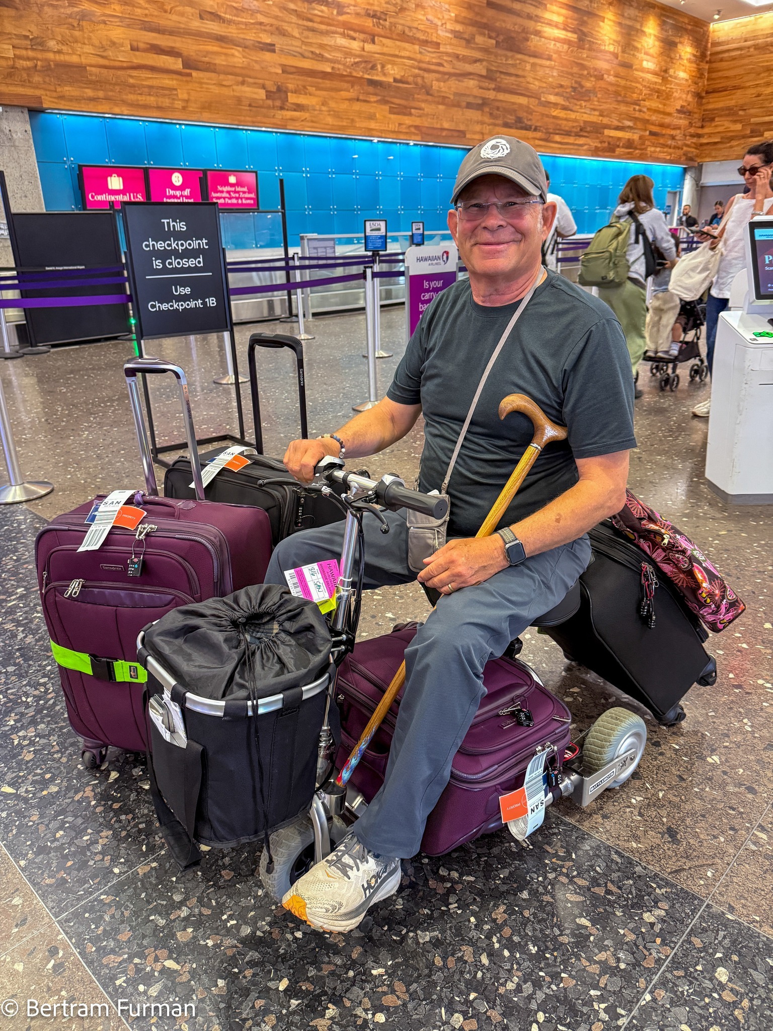 Man with much luggage on mobility scooter.